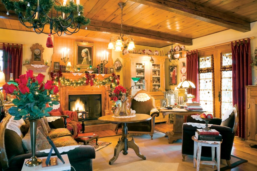 View of a lavishly decorated living room at Christmas time in an Old reconstructed (1977) Canadiana Cottage style Residential Log Home, Laval, Quebec, Canada. This image is property released.