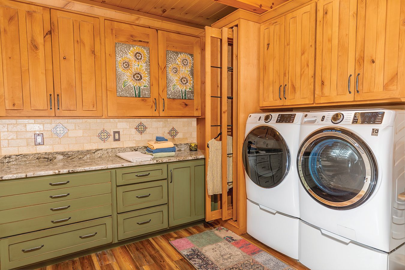 Built in cabinets and counter space help keep the laundry room functional and organized